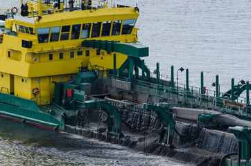 Fototapeta na wymiar HOPPER DREDGER - A specialized vessel works on the fairway in the port 
