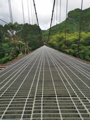 Steel suspension bridge over the river