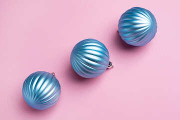 Shiny blue balls on a pink background, Christmas decorations