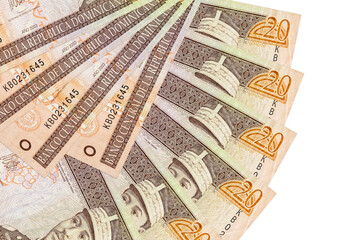 20 Dominican peso bills lies isolated on white background with copy space stacked in fan shape...