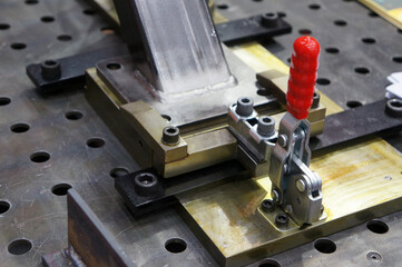 Close up workpieces and clamping jig with manual quick clamp for  welding process at factory    