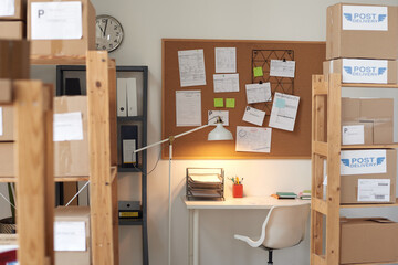 Image of board with notes hanging on the wall above the table at empty office
