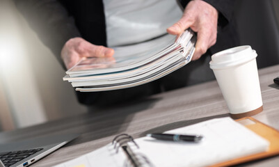 Male hands holding magazines