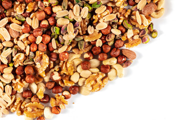 Nuts assortment background with a place for text. Many different nuts, shot from the top on white