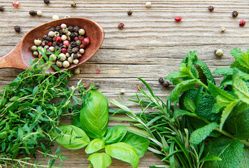 Fresh herbs and spices on wooden background top view