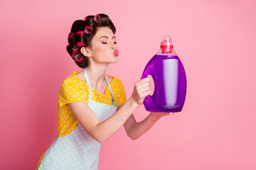 Photo of maid send air kiss washer powder liquid wear yellow dotted t-shirt isolated pastel color...