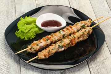 Minced pork skewer kebab with sauce