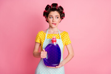 Unsure girl hold wash powder bottle bite lips look copyspace hesitate wear yellow dotted t-shirt...