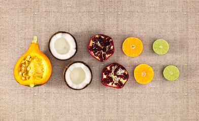 Flat lay tropical exotic fruits. Healthy summer food ingredients: cocos, Orange, lime, pomegranate...