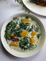 Coconut soup with mulberry leaves and  pumpkin flesh for lunch known in Malay as ‘Masak lemak...