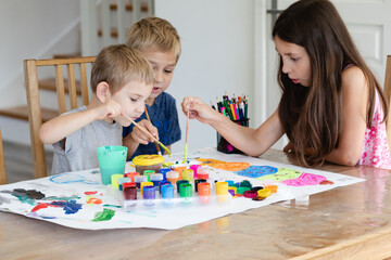 Fototapeta premium Cooperation between brothers and sister while creative process