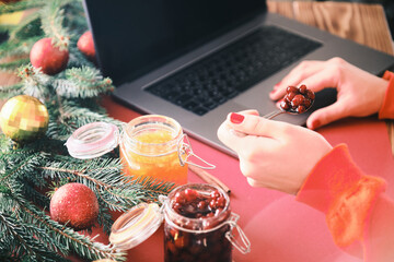 Female hands putting jam on a crispbreads closeup. Christmas breakfast