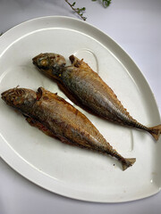 Stuff fried hard tail scad fish on a plate known in Malay as ‘Ikan goreng cencaru sumbat’