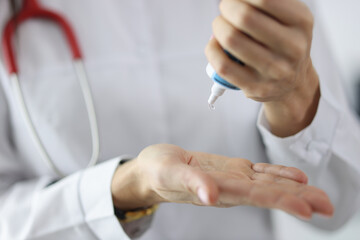 Doctor squeezes gel from tube onto hand. Medical ultrasound gel concept
