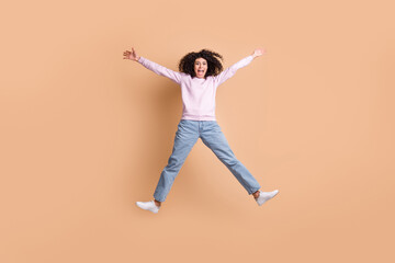Fototapeta na wymiar Full body portrait of attractive excited lady jumping raise hands open mouth shout isolated on brown color background