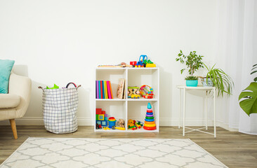 Organized space with children's toys and books - 395236488