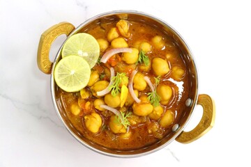 Indian food. Fresh chickpea masala, Chole masala curry, traditional north Indian dish. Popular Amritsari Chole bhature. Chana masala Garnished with lemon and onion. food photography. Copy space.