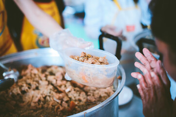 Providing free food to the poor : The hands of beggars receive donated food