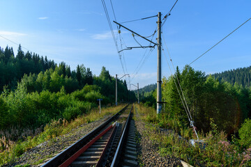 Railway track in the forest in a mountainous area
