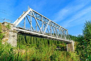 Fototapeta premium Metal railway bridge over the river