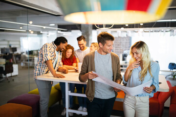 Successful group of designers, business people at work in office