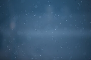 blue snowfall bokeh background, abstract snowflake background on blurred abstract blue