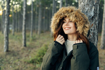 Woman warm jacket with a hood on nature Autumn forest travel