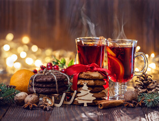 Close-up of traditional Christmas mulled wine with spices and cookies on Christmas market