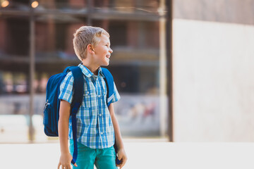 Cute boy going to school with backpack