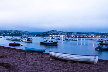 Boats moored on the Teign river in between Shaldon and Teignmouth, Devon at Dusk.