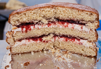 A Victoria sponge cake on sale at an artisan market.