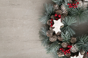 Part of Christmas wreath on light background. New year decor, copy space