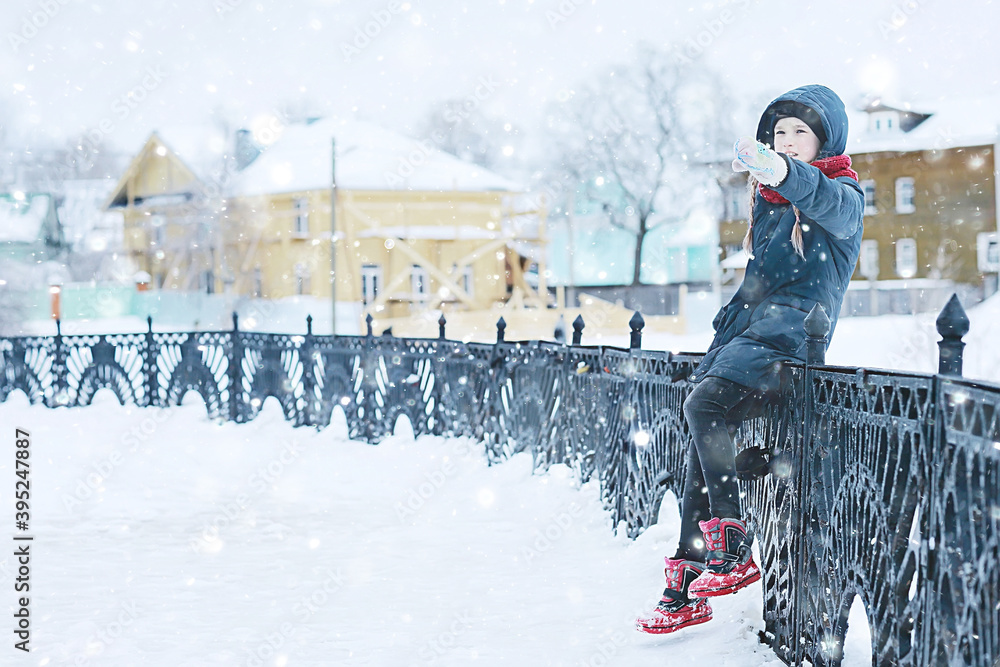 Wall mural girl in winter for a walk in the park / seasonal photo of a child in warm clothes. Winter landscape with a child. Walk frost, urban style, upbringing,, christmas vacation