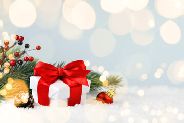 Christmas gift box and fir tree in a snowdrift