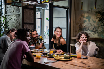 Multi-ethnic group of friends having a good time in a cafe.