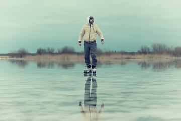 one guy skates on the ice of a frozen lake, nature landscape, man outdoor sports