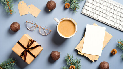 Christmas office table with coffee cup, gift box, computer keyboard, glasses, Xmas decorations, Christmas card on pastel blue background. Flat lay, top view. New Year workspace.