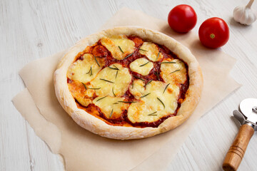 Homemade Margherita Pizza with Mozzarella and Rosemary, side view.