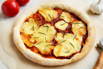 Homemade Margherita Pizza with Mozzarella and Rosemary, side view.  Close-up.
