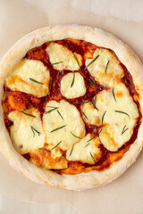 Homemade Margherita Pizza with Mozzarella and Rosemary, top view. Flat lay, overhead, from above. Close-up.