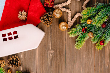 Christmas background with ornaments and ceramic house in Scandinavian style on a wooden table