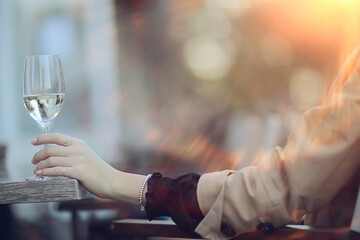 white wine glass in an outdoor cafe, spring view in a restaurant