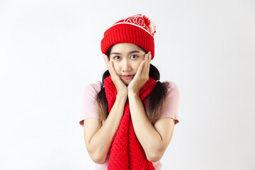 A cute young asian woman wearing red wool hat and scart posing on the white background
