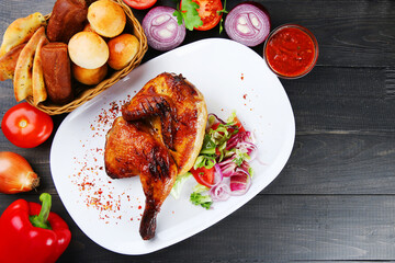 turkey or chicken on wooden table and ingredients. Christmas or Thanksgivin table