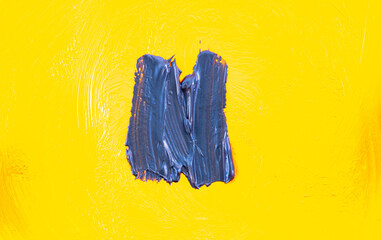 Blue paint brush stroke on yellow background