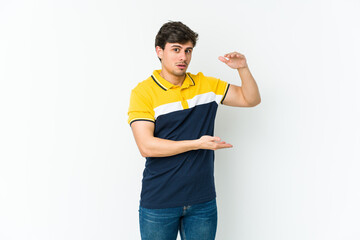 Young cool man holding something with both hands, product presentation.