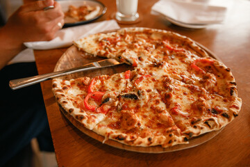 Delicious home made pizza on wooden background