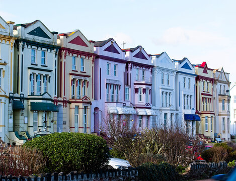 A colourful terrace of houses along the front at Paignton, Devon, England, UK.