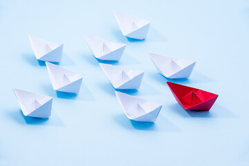 Red and white paper boats. Concept of leadership boats for teamwork group or success.