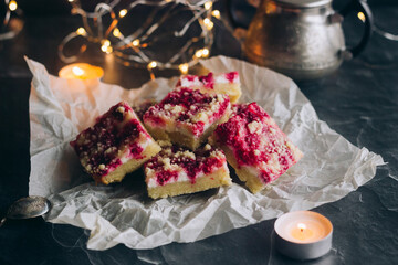 Delicious pie with raspberries and curd cheese. Pieces of pie on the table